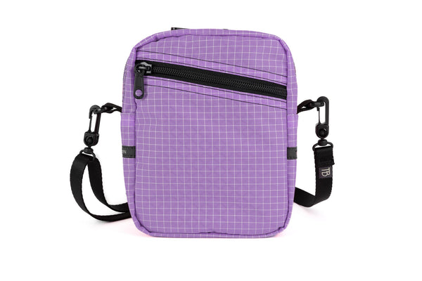 An Everyday Cubelet in Wisteria Halcyon (pale purple with a white grid) with a front zipper.